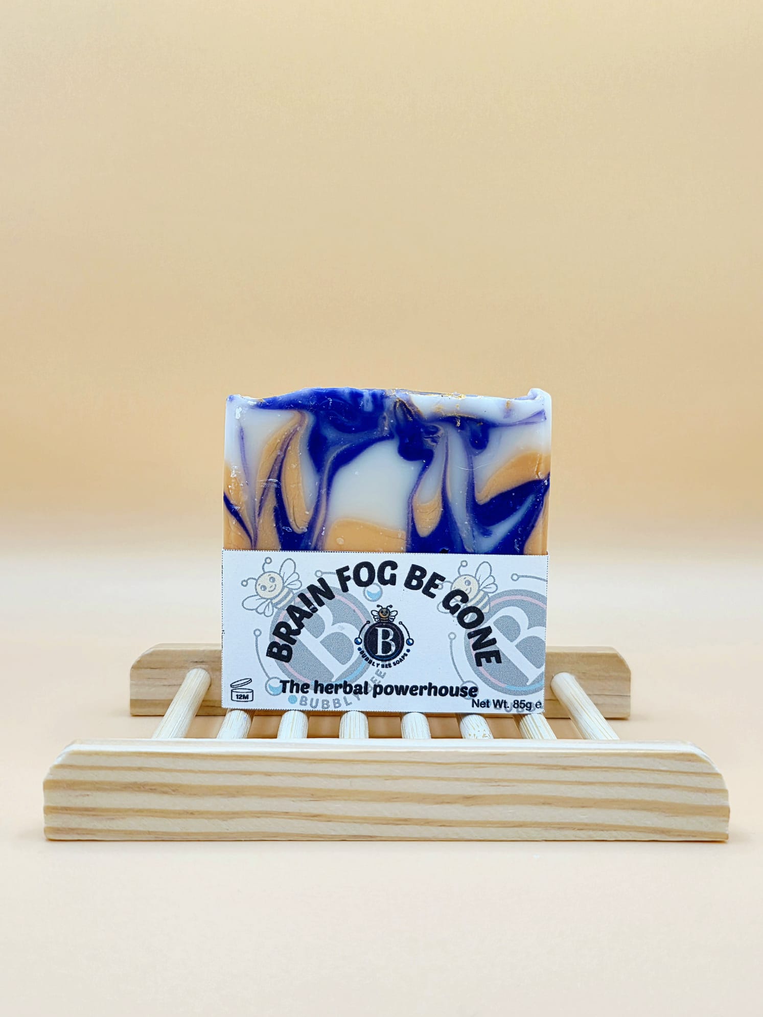 Bar of soap with a label on a wooden stand against a beige background
